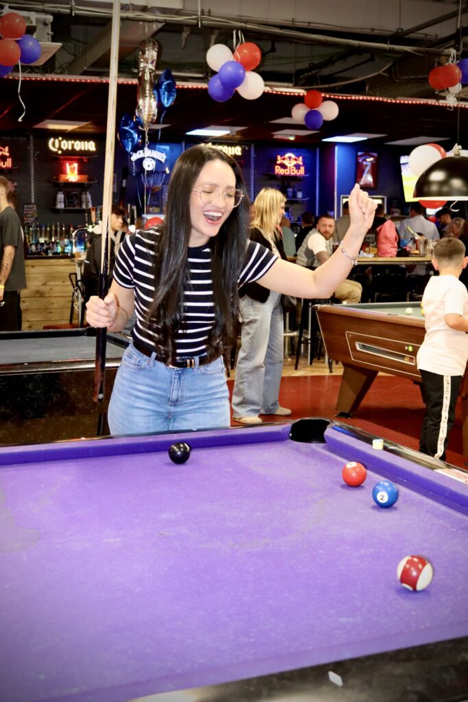 Girl Playing pool at no name bar and games, Colchester