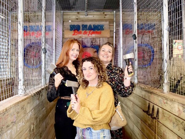 Axe throwing lanes at No Name Bar & Games Colchester three ladies holding axes